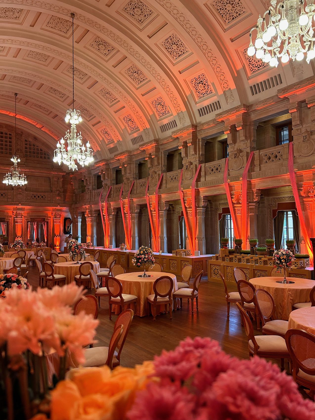 Palace banquet hall dressed with uplighting, florals and banquet seating